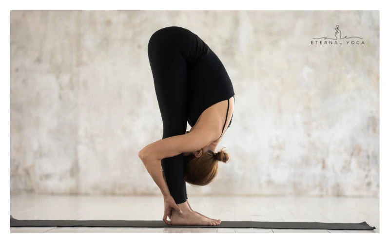 women in standing forward fold yoga position